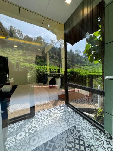 a bedroom with a view of a bed and a balcony at IRON BRIDGE COVE in Meppādi