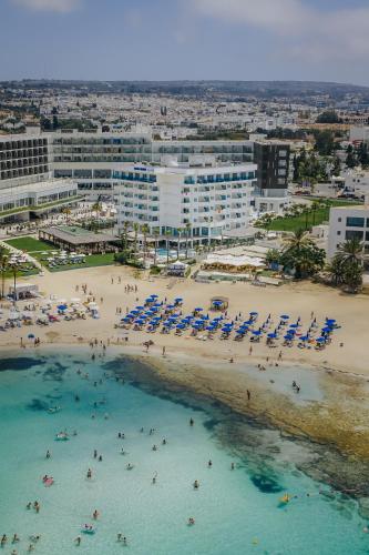 an aerial view of a beach with people and chairs at Tasia Maris Sands (Adults Only) in Ayia Napa