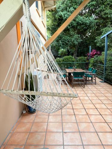 a hammock hanging from the side of a house at River Rock Retreat in Maroochy River