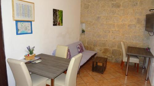 a dining room with a table and chairs at Apartments Eldi in Split