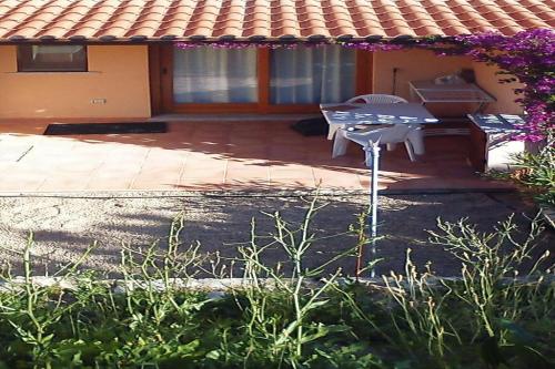 a patio with a picnic table and a grill at Apartment in Porto Pollo near Sea Beach in Porto Pollo