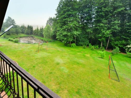 a view of a yard from a balcony at Comfortable holiday villa, Święcianowo in Zegocino