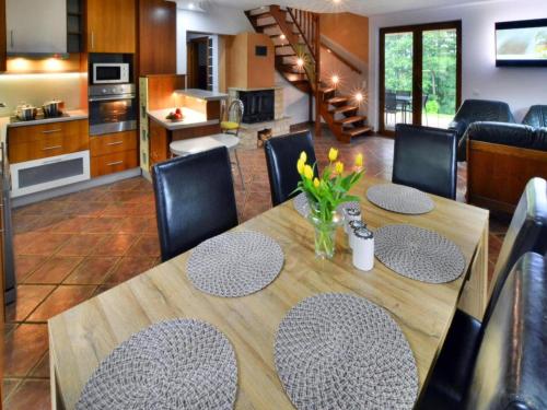 a dining room and kitchen with a table and chairs at Comfortable holiday villa, Święcianowo in Zegocino