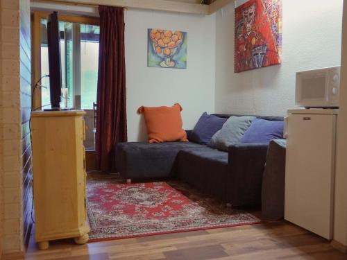 a living room with a couch and a television at Apartment in Tauplitz near Ski Lift in Tauplitz