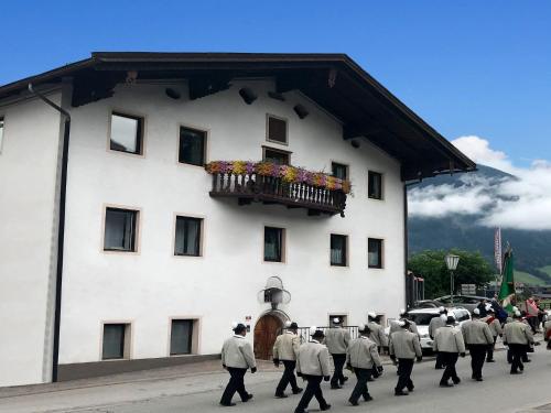 a group of men walking in front of a building at Apartment building, Fügen in Fügen