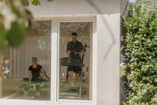 a man and a woman are reflected in a window at Landhotel Stähle in Schüttorf
