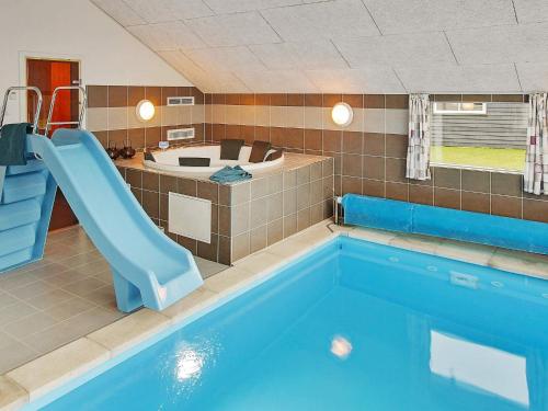 a swimming pool with a slide and a blue swimming pooliterator at 5 star holiday home in Kappeln in Kappeln