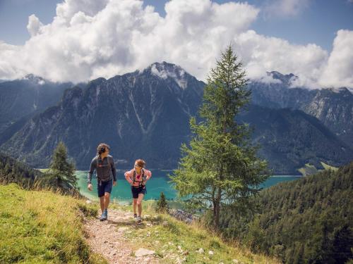 two people walking on a trail in the mountains at Apartment at the Achensee in Achensee