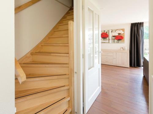a staircase with wood treads in a house at Holiday Home near Lutjestrand Beach in Oosterklief
