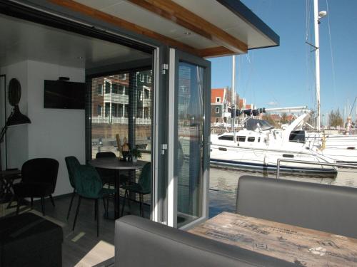 a dining room with a view of a marina at Boat in Volendam near Marina Museum in Volendam