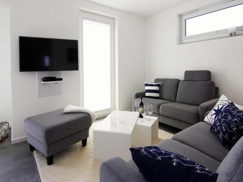 ペーネミュンデにあるFerienhaus am Yachthafen in Peenemuendeのソファと椅子のあるリビングルーム