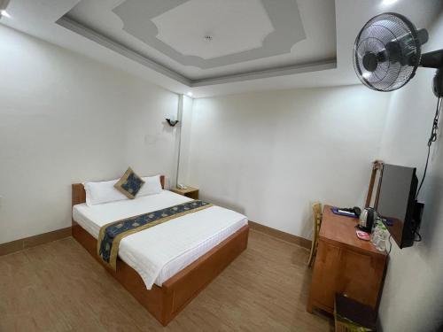 a small bedroom with a bed and a fan at My Dream Hotel in Vung Tau