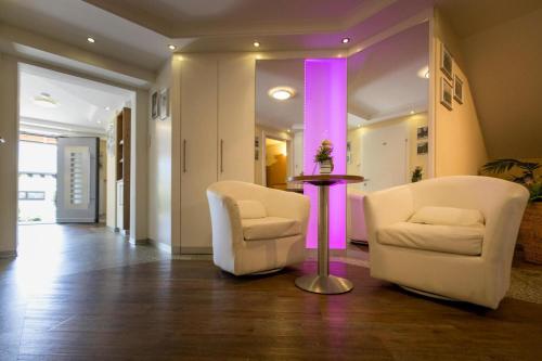 a living room with two chairs and a table at Holiday flats in St Georgen am Kreischberg in Sankt Georgen ob Murau