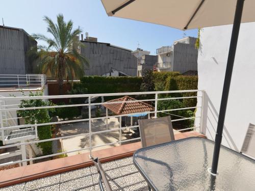 a balcony with an umbrella and a table and chairs at Vacation home with private pool, Floridia in Floridia
