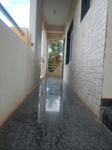 an empty hallway of a building with water on the floor at Single Bedroom Full independent house walkable distance to Dasarahalli Metro in Bengaluru