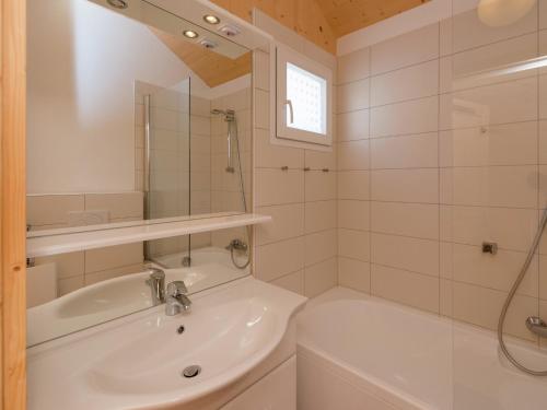 a white bathroom with a sink and a shower at Chalet in Hohentauern near Ski Lift in Hohentauern