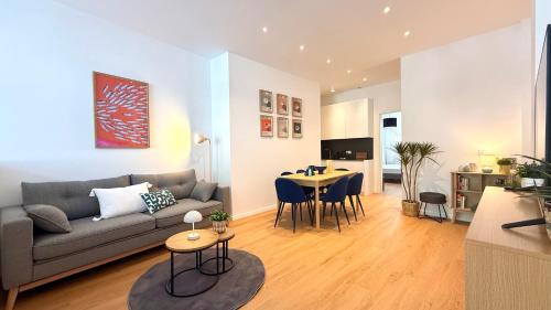 a living room with a couch and a table at BeckHomes Munich - Stylish Central Apartments in Munich