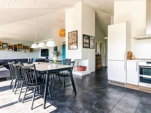 a kitchen and dining room with a table and chairs at Karrebæksminde Fjord Houses in Karrebæksminde