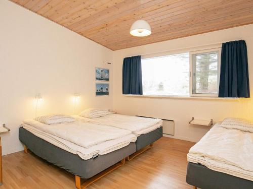 a bedroom with two beds and a window at Vigsø Holiday Center in Hanstholm