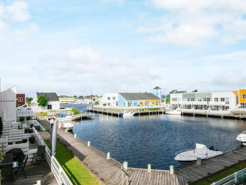 a marina with boats in the water and buildings at Islands Maritime Holiday Village Ebeltoft in Ebeltoft