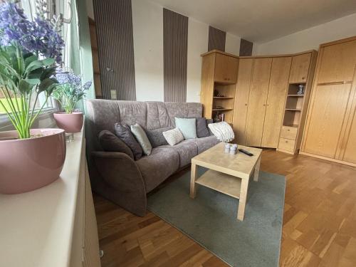 a living room with a couch and a coffee table at Tief 10 mit beheiztem Pool - Meerengel 1001 in Wangerland