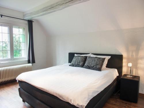 a bedroom with a large white bed with two pillows at Mansion in Spa Liege with private garden in Spa