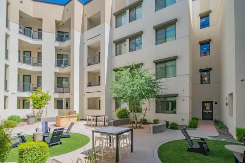 a courtyard with tables and chairs in front of a building at TPC Golf & Pool Peaceful Getaway in Kierland in Scottsdale