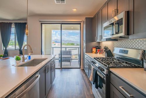 a kitchen with a sink and a stove at TPC Golf & Pool Peaceful Getaway in Kierland in Scottsdale