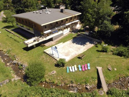 an aerial view of a large building with a pool at Auberge de Jeunesse HI Le Mont-Dore in Le Mont-Dore