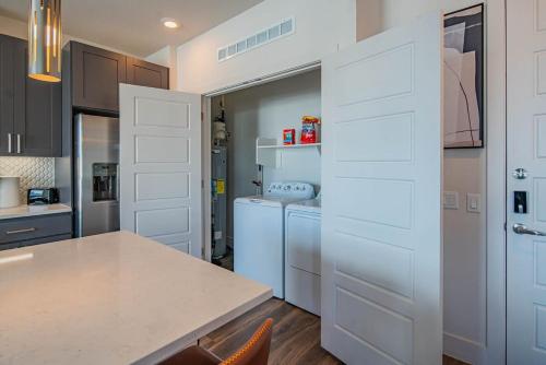 a kitchen with white cabinets and a counter top at TPC Golf & Pool Peaceful Getaway in Kierland in Scottsdale