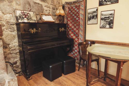 a table and a piano in a room with a table and chairs at Casa Barría in Pradoluengo