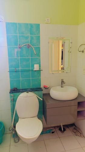 a bathroom with a toilet and a sink at Airnova 2BHK in Sonīpat