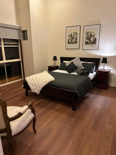a bedroom with a bed and a chair at River Rock Retreat in Maroochy River