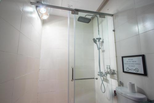 a bathroom with a shower and a toilet at NT Elysian hotel in Hanoi