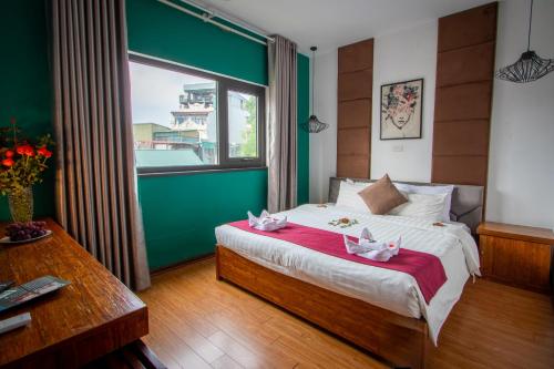 a bedroom with a large bed and a window at NT Elysian hotel in Hanoi