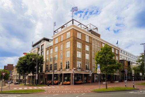 a building with two flags on top of it at City Hotel Haarhuis, World Hotels Crafted Collection in Arnhem