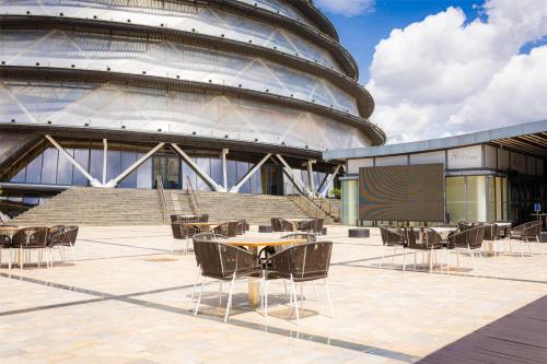 a amphitheater with tables and chairs in front of a building at Radisson Blu Hotel & Convention Centre Kigali in Kigali