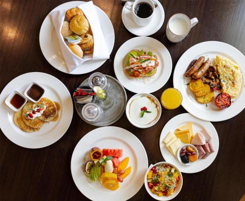 a table topped with white plates of food at Radisson Blu Hotel & Convention Centre Kigali in Kigali