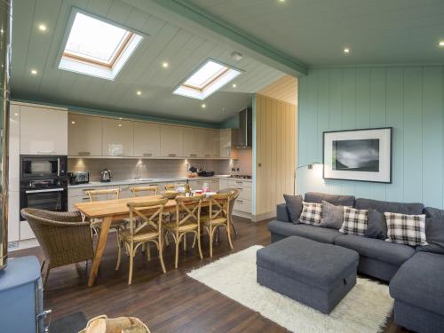 a living room with a couch and a table at Aberdaron Lodge in Aberdaron