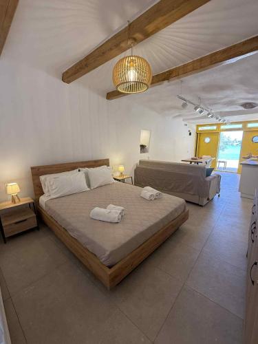 a bedroom with a large bed and a couch at Boathouse Kimolos Rema in Kimolos