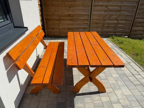 a wooden bench sitting next to a building at Zajazd Tadeo in Pietrzykowice