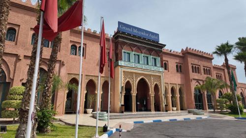 a university building with flags in front of it at Grand Mogador Agdal & Spa in Marrakech