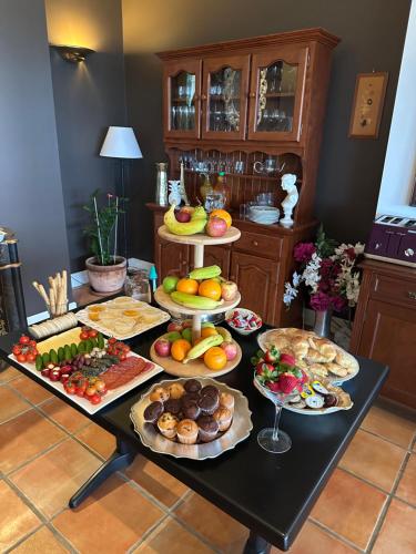 a table with many plates of food on it at River Rock Retreat in Maroochy River