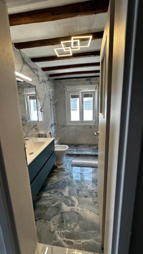 a bathroom with a toilet and a sink at Steven Eleonas apartments in Eleonas