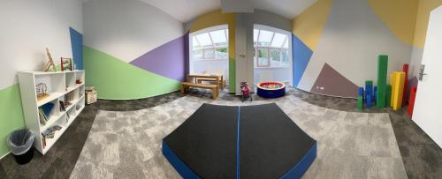 a childs room with a play room with a large table at Hotel am Schloß Apolda in Apolda