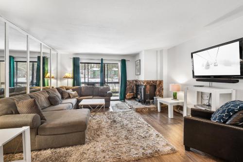 a living room with a couch and a flat screen tv at 2 Bedroom Kirkwood Condo – Base Camp condo in Kirkwood