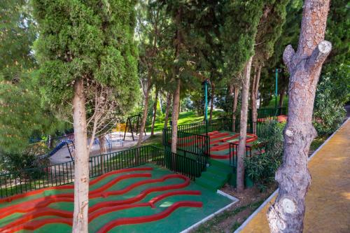 a playground with a red carpet in a park at AluaSun Costa Park in Torremolinos