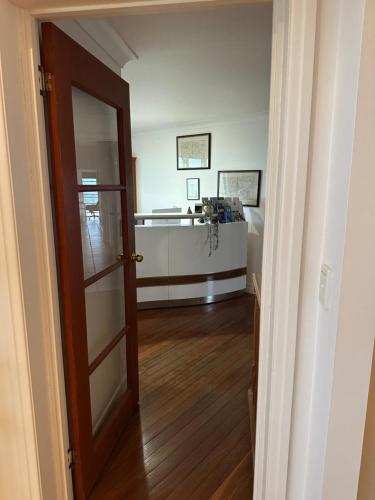 a hallway with a door leading to a living room at River Rock Retreat in Maroochy River