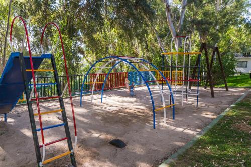 a park with a playground with a colorful play equipment at AluaSun Costa Park in Torremolinos