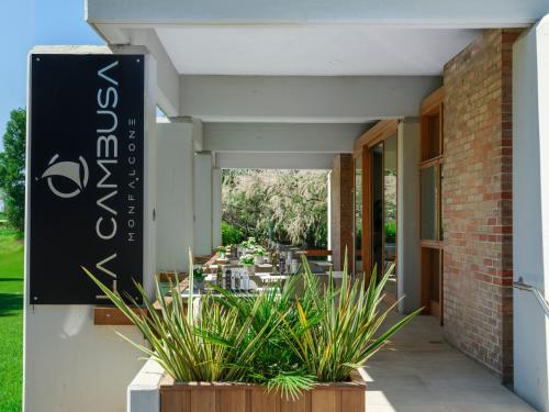 a sign on the side of a building with plants at Boutique Guesthouse - Marina Monfalcone in Monfalcone